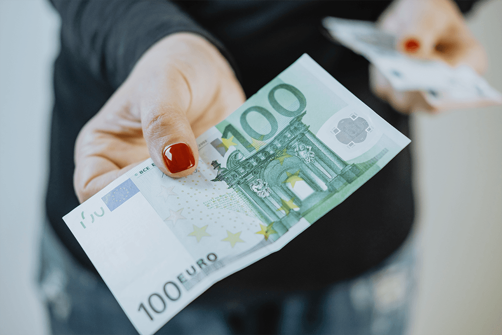 100-euro-in-womens-hands-and-a-wallet